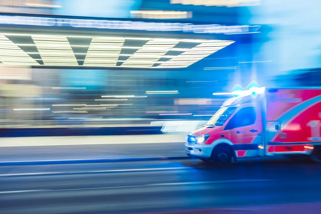 An ambulance rushes down a city street.