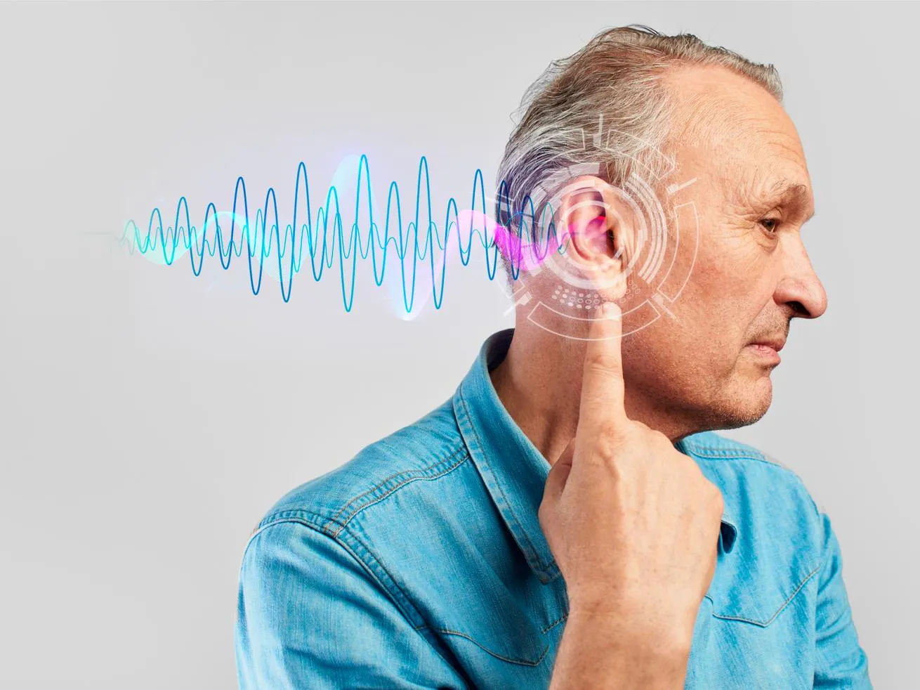 A man points to his ear with a graphic representation of audio emanating from the ear canal