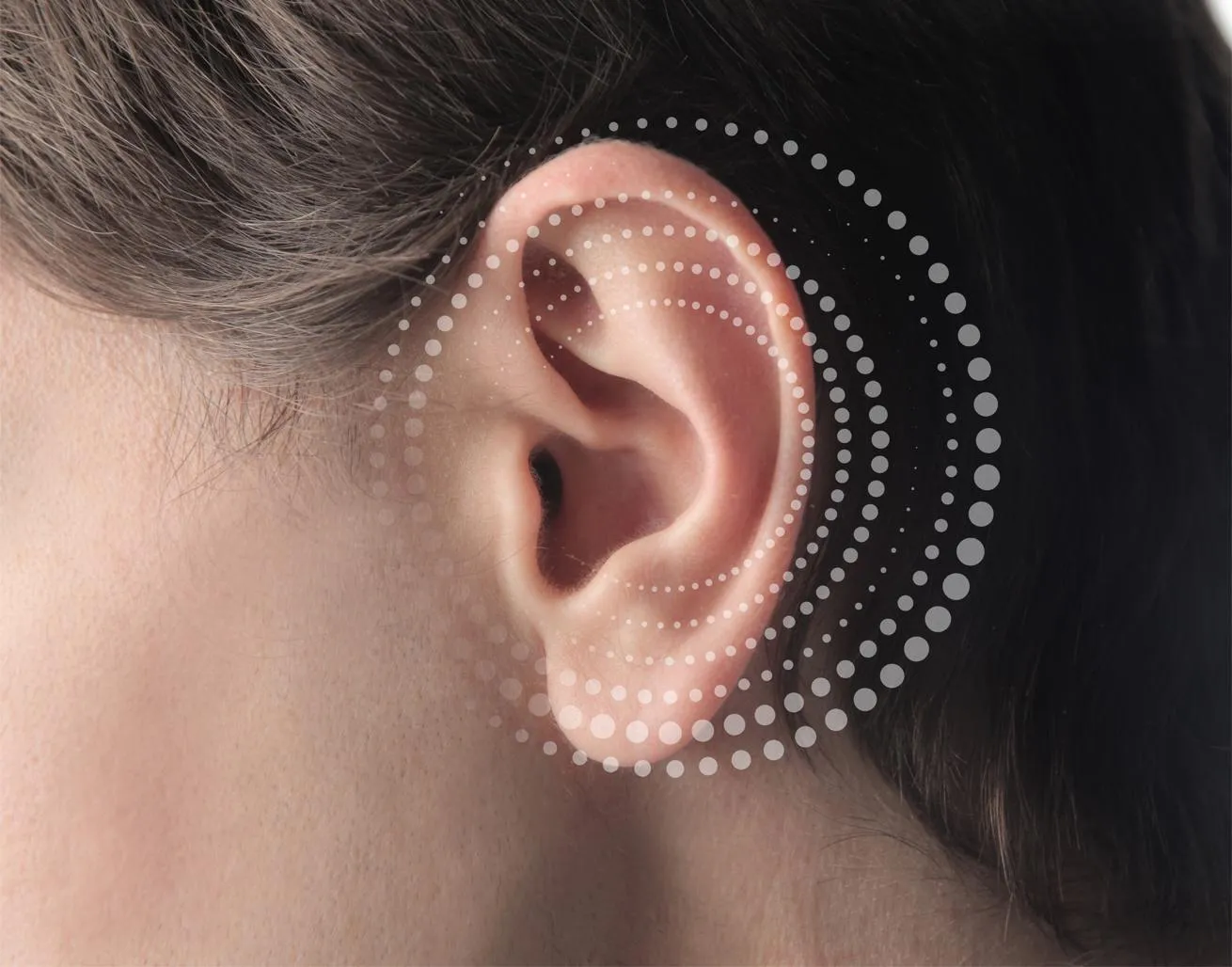 Close up of a woman’s ear with concentric rings around it.
