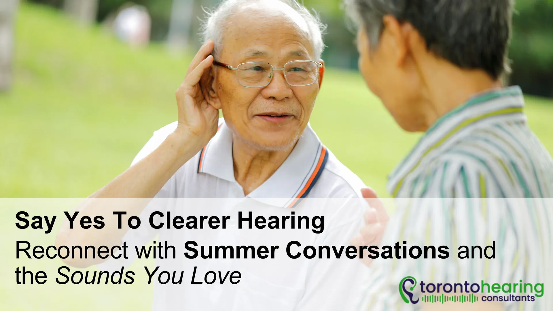 Older man cupping his ear to hear better while chatting with a friend outdoors, promoting clearer hearing and summer connection – Toronto Hearing Consultants.