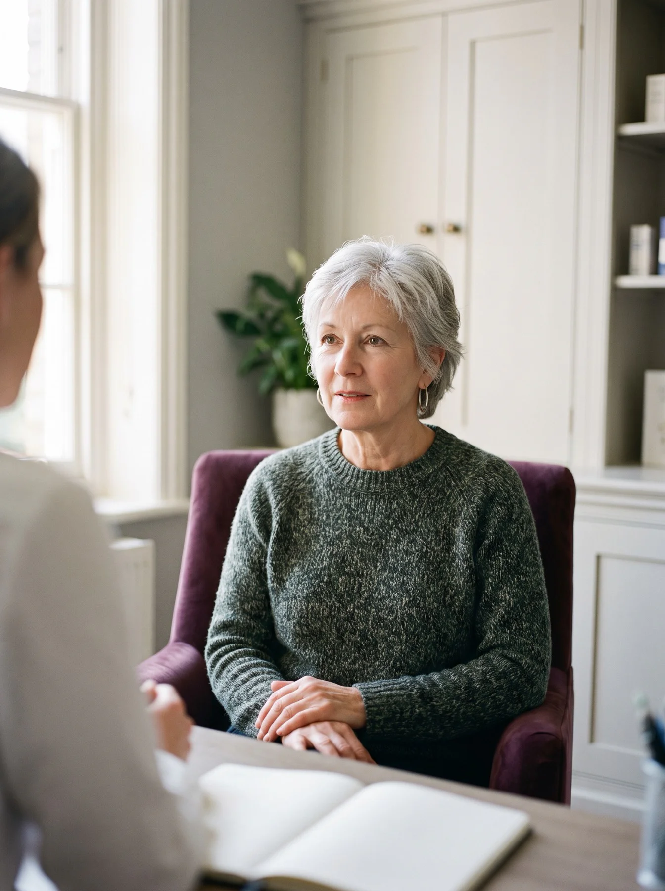 Audiologist listening to a patient