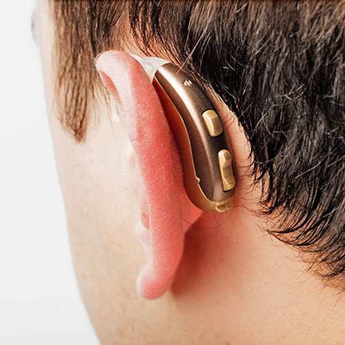 An image of a person wearing a modern Behind-the-Ear hearing aid.